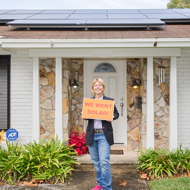 solar homeowner in Orlando with we went solar sign and solar home