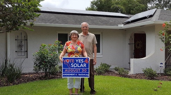 Florida Co-op members with Vote Yes 4 Solar Sign