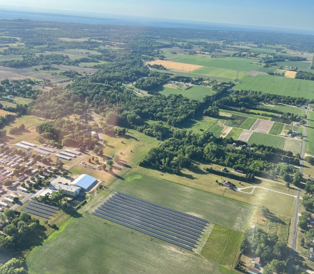 Aerial view of countryside with lines solar panels 